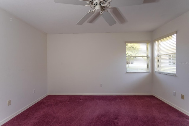 carpeted spare room with baseboards and ceiling fan