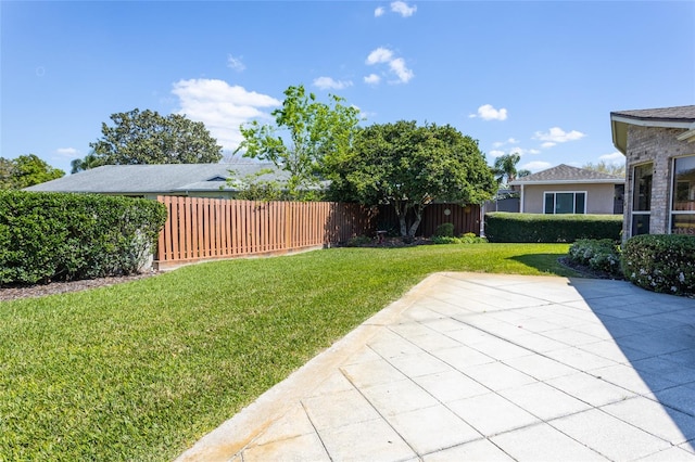 view of yard with a patio and fence