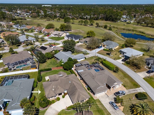 drone / aerial view featuring a residential view, golf course view, and a water view