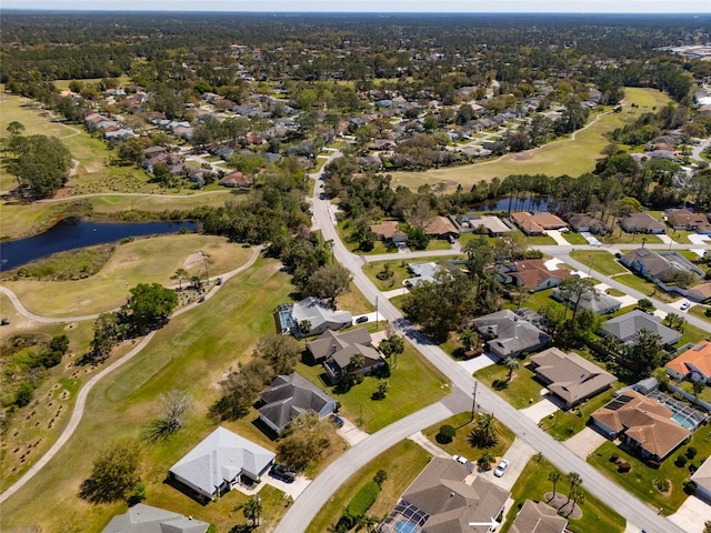 drone / aerial view with a residential view, golf course view, and a water view