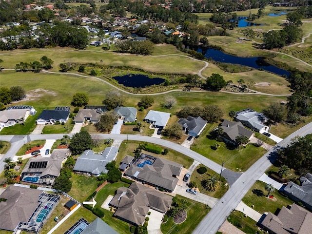 aerial view featuring a residential view, golf course view, and a water view