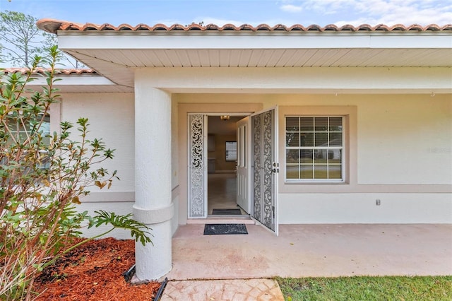 property entrance with stucco siding