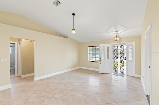 unfurnished room featuring vaulted ceiling, light tile patterned flooring, baseboards, and visible vents