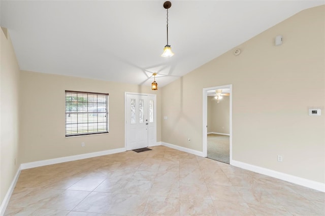 entryway with baseboards and lofted ceiling