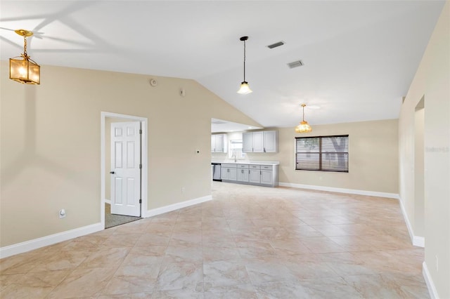 unfurnished living room featuring visible vents, baseboards, and vaulted ceiling