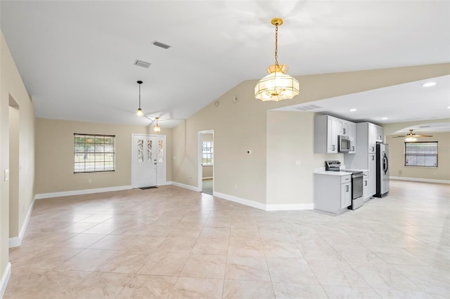 interior space featuring a wealth of natural light, visible vents, ceiling fan, and vaulted ceiling