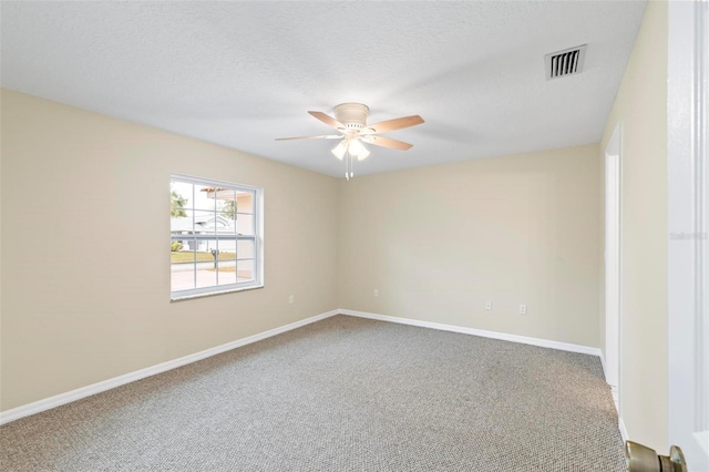 carpeted spare room with visible vents, a textured ceiling, a ceiling fan, and baseboards