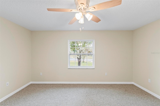 carpeted spare room with baseboards, a textured ceiling, and ceiling fan