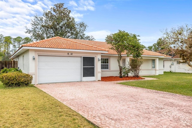 view of front facade featuring a front lawn, fence, a garage, and stucco siding