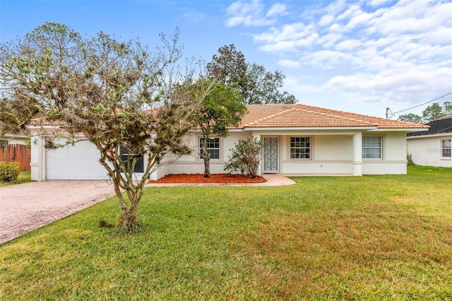 ranch-style house featuring stucco siding, a tile roof, decorative driveway, and a front yard