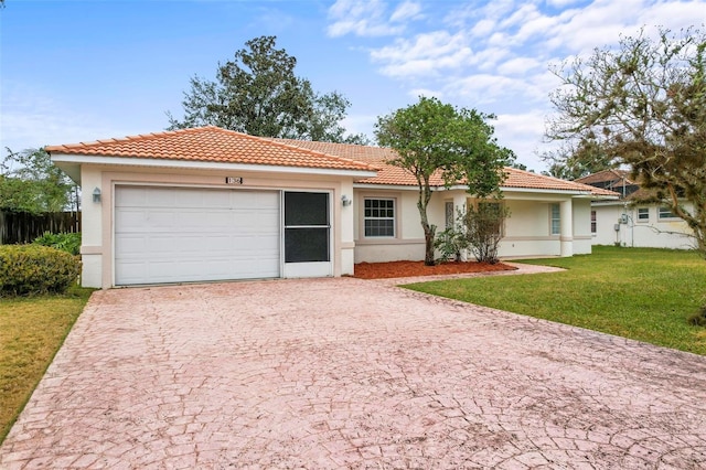 view of front of property with stucco siding, decorative driveway, a front yard, a garage, and a tiled roof