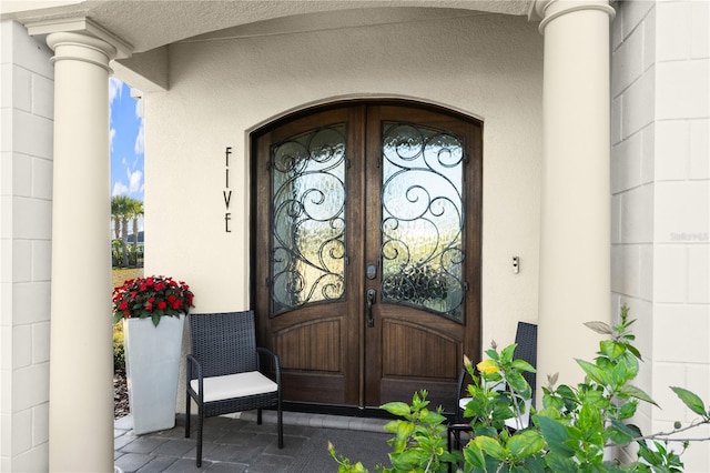 property entrance with french doors and stucco siding