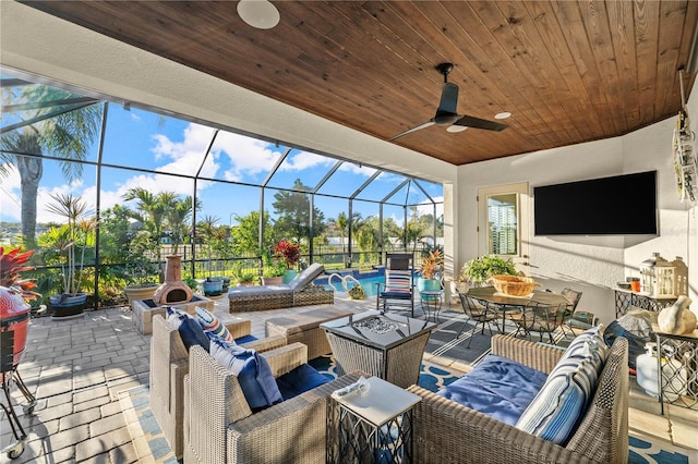 view of patio / terrace featuring a ceiling fan, an outdoor pool, outdoor dining area, an outdoor hangout area, and a lanai