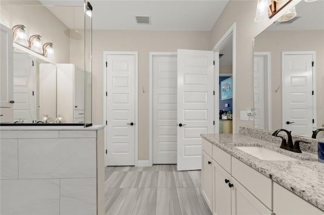 bathroom with visible vents and vanity