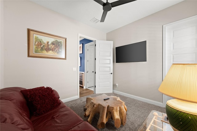 carpeted living area with visible vents, baseboards, and a ceiling fan