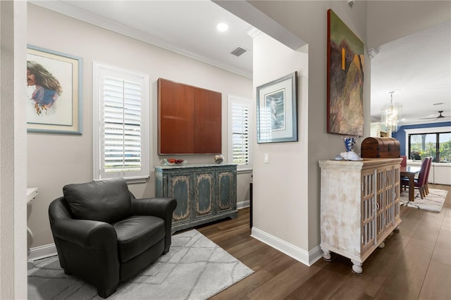 sitting room featuring visible vents, recessed lighting, crown molding, baseboards, and dark wood-style flooring