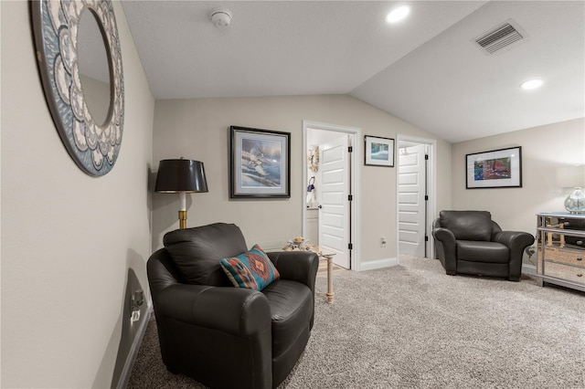 carpeted living area with visible vents, recessed lighting, baseboards, and vaulted ceiling