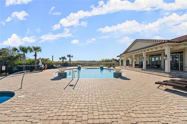 pool featuring a patio area and fence