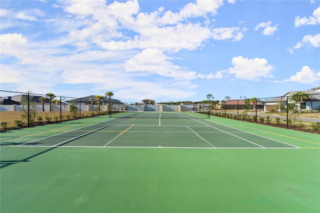 view of sport court featuring fence