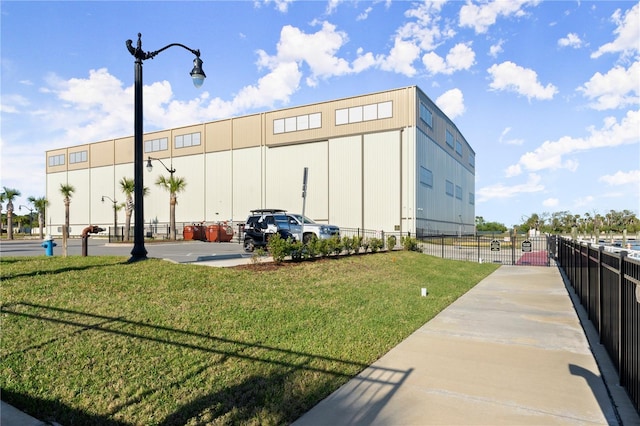 view of property with uncovered parking and fence