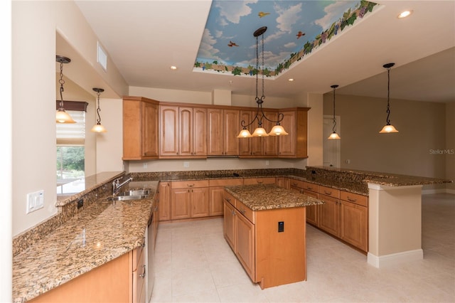 kitchen with dark stone countertops, a kitchen island, a peninsula, recessed lighting, and a sink