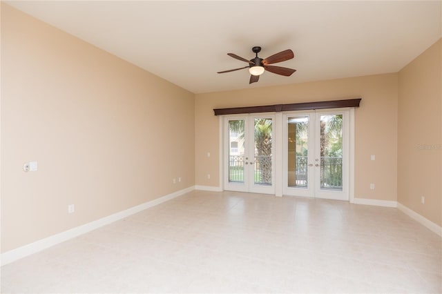 spare room with french doors, baseboards, and ceiling fan