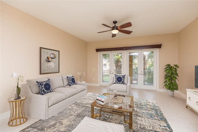 living room featuring light tile patterned flooring, french doors, a ceiling fan, and baseboards