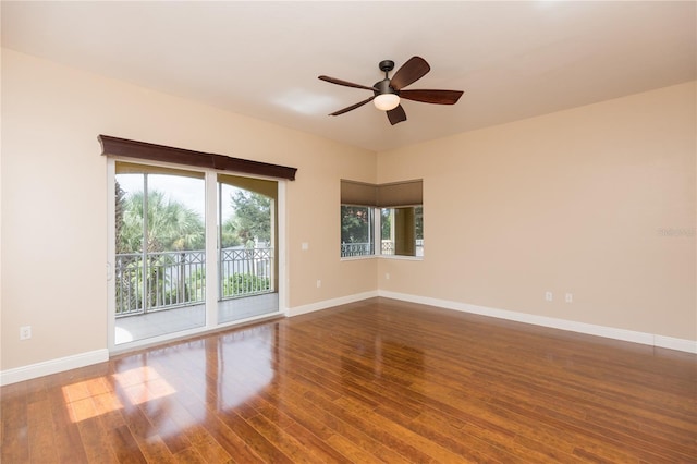 unfurnished room featuring baseboards, wood finished floors, and a ceiling fan