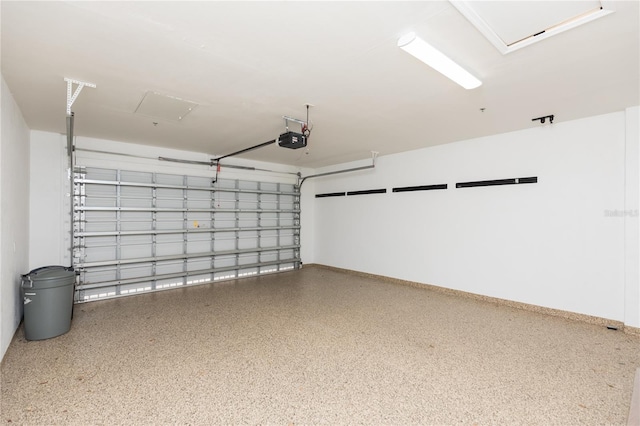 garage featuring a garage door opener and baseboards