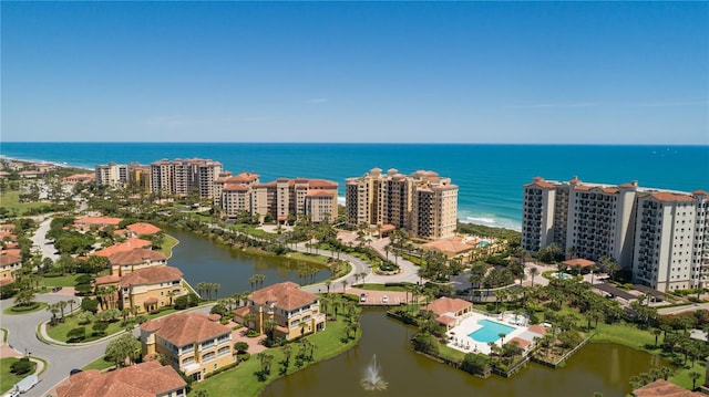 birds eye view of property featuring a view of city and a water view