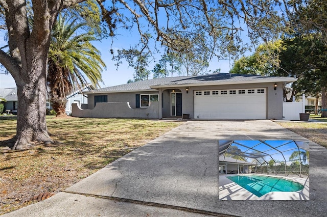 ranch-style home with driveway, an attached garage, an outdoor pool, stucco siding, and a lanai