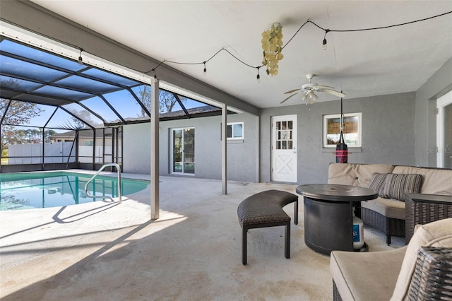 view of swimming pool with a lanai, a patio, ceiling fan, and outdoor lounge area