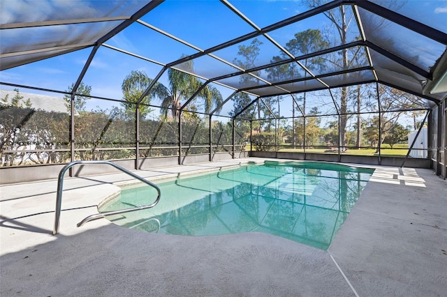 pool featuring glass enclosure and a patio