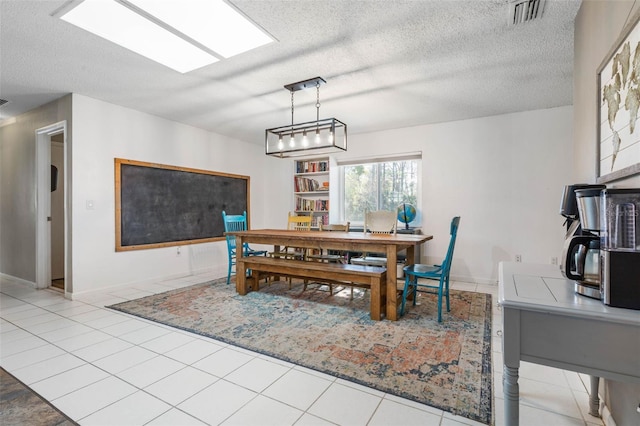 tiled dining area featuring visible vents and a textured ceiling