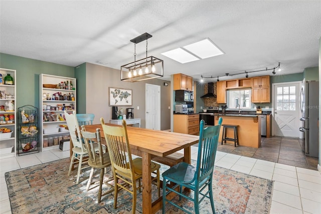 dining room featuring light tile patterned floors and a textured ceiling