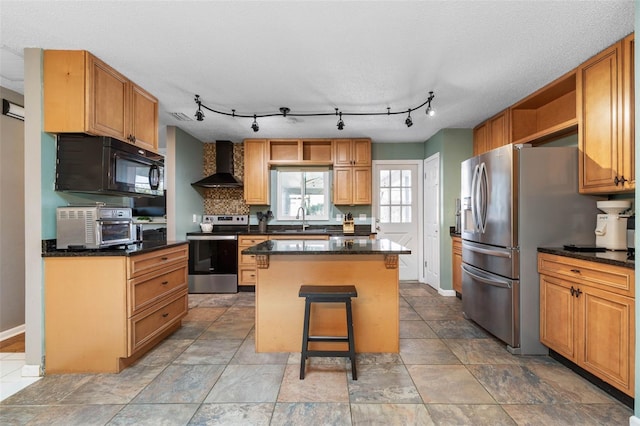 kitchen featuring a sink, a center island, appliances with stainless steel finishes, wall chimney exhaust hood, and open shelves