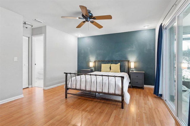 bedroom with baseboards, visible vents, and light wood finished floors