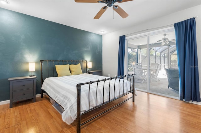 bedroom featuring wood finished floors, a ceiling fan, baseboards, and access to outside