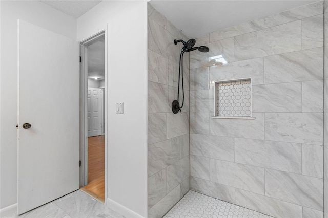 bathroom featuring tiled shower