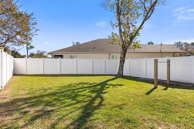 view of yard with a fenced backyard