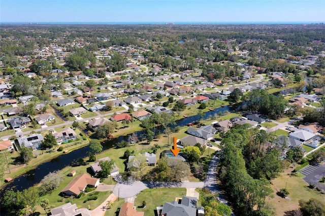 birds eye view of property with a residential view and a water view