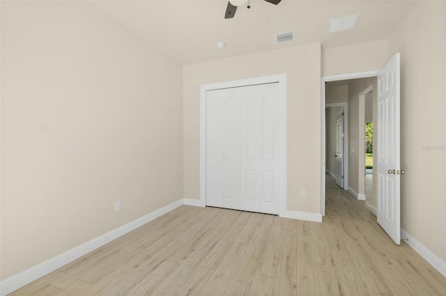 unfurnished bedroom featuring visible vents, baseboards, and light wood-style floors