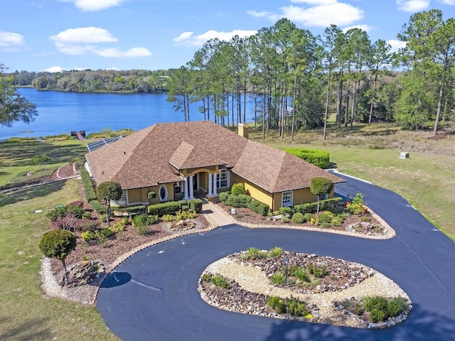 view of front facade featuring a water view and stucco siding