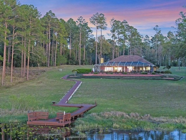 view of community featuring a yard and a water view