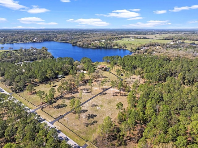 aerial view with a wooded view and a water view