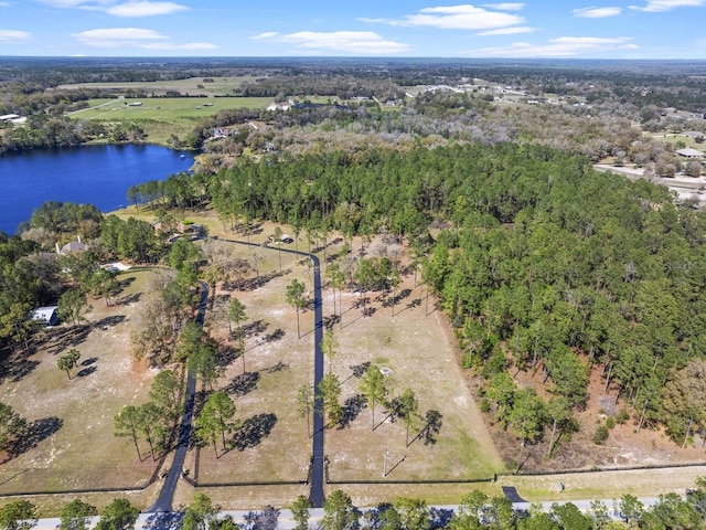 aerial view with a forest view and a water view