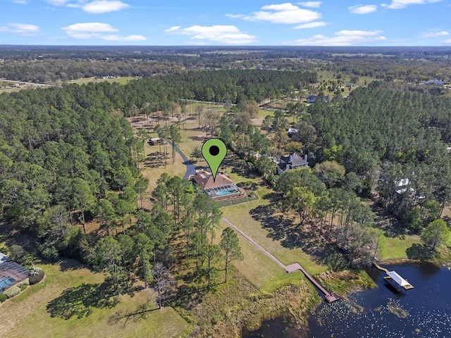 aerial view with a forest view and a water view