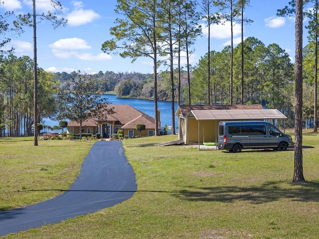 view of front of home with a water view and a front lawn