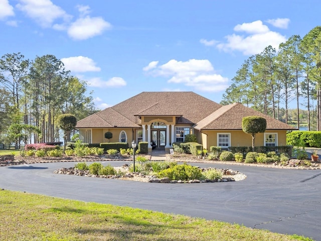 view of front of property with stucco siding and french doors