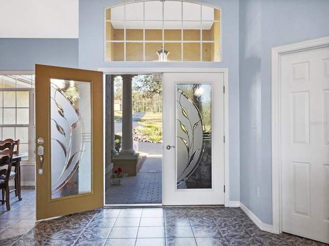 foyer with french doors and baseboards